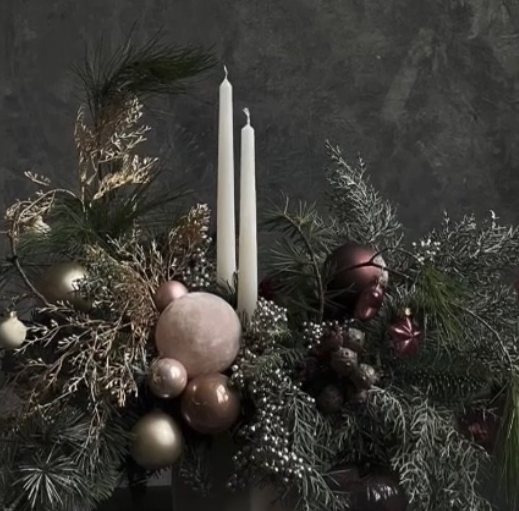 Frosted silver and sage Christmas arrangement with white taper candles and ornaments